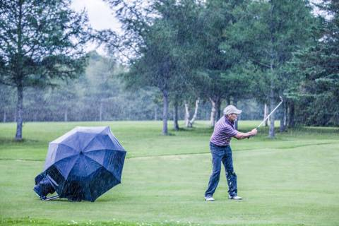 playing golf in the rain